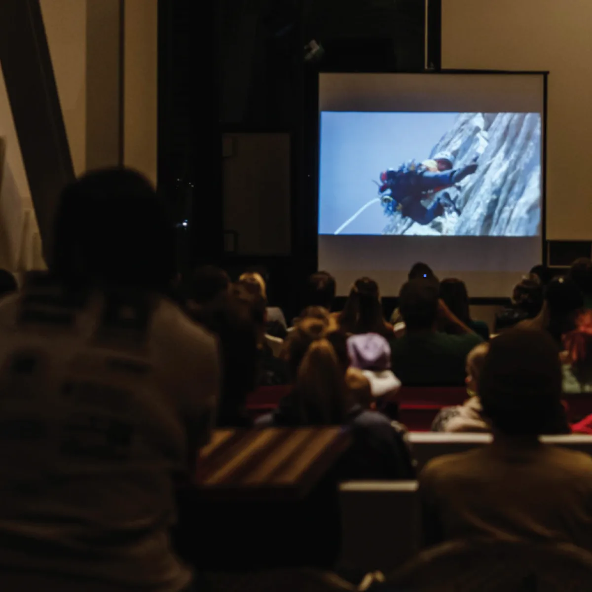 Audience watching a climbing film in the Community Room