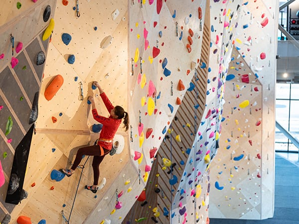 A woman climbs at an indoor rock climbing gym in Salt Lake City Utah