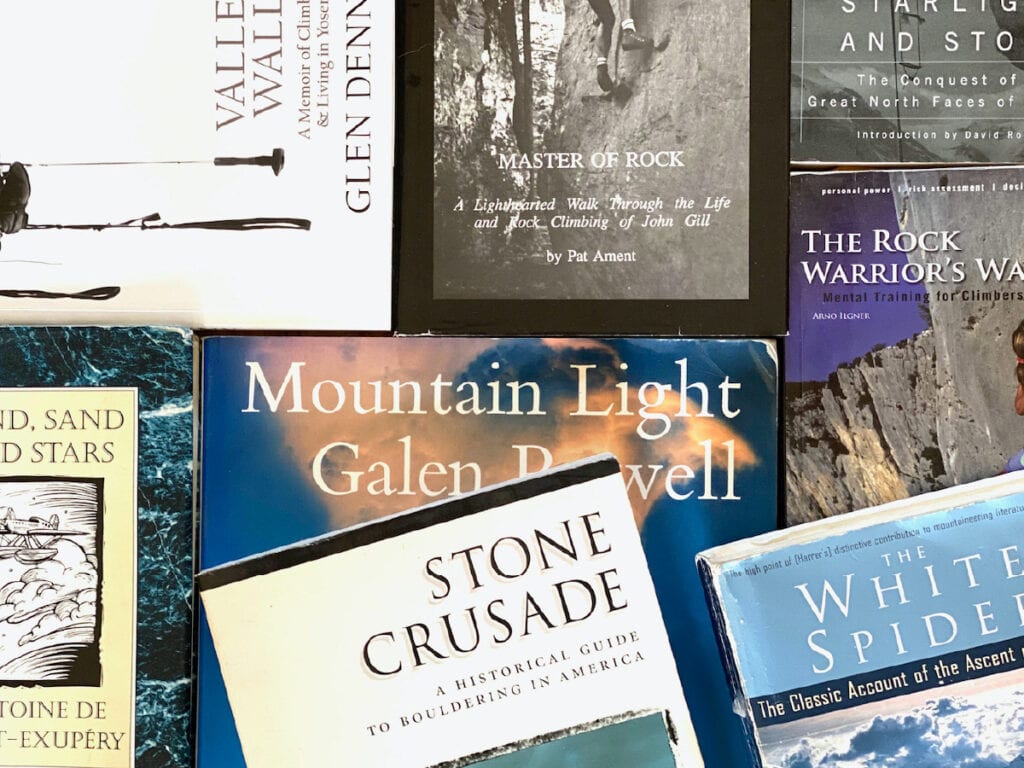 A collection of classic climbing books sit on a table